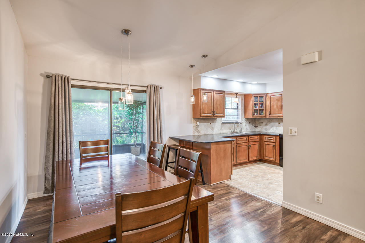 332 Shamrock Road St. Augustine, FL 32086 - Photo 9 of 26 a living room with kitchen view and a wooden floor