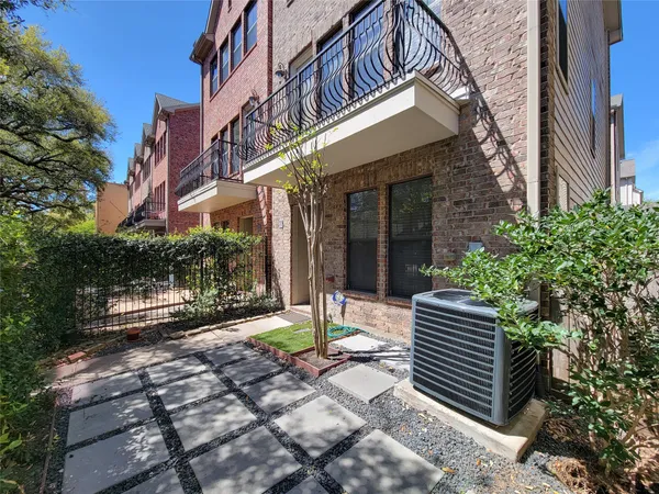 a view of a building with sitting area and garden
