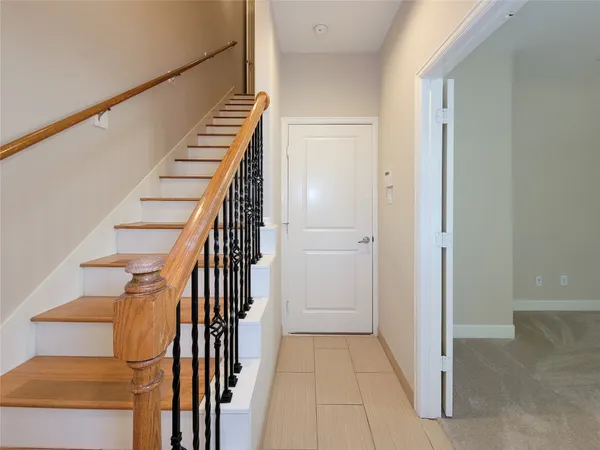 a view of entryway and gallery with wooden floor