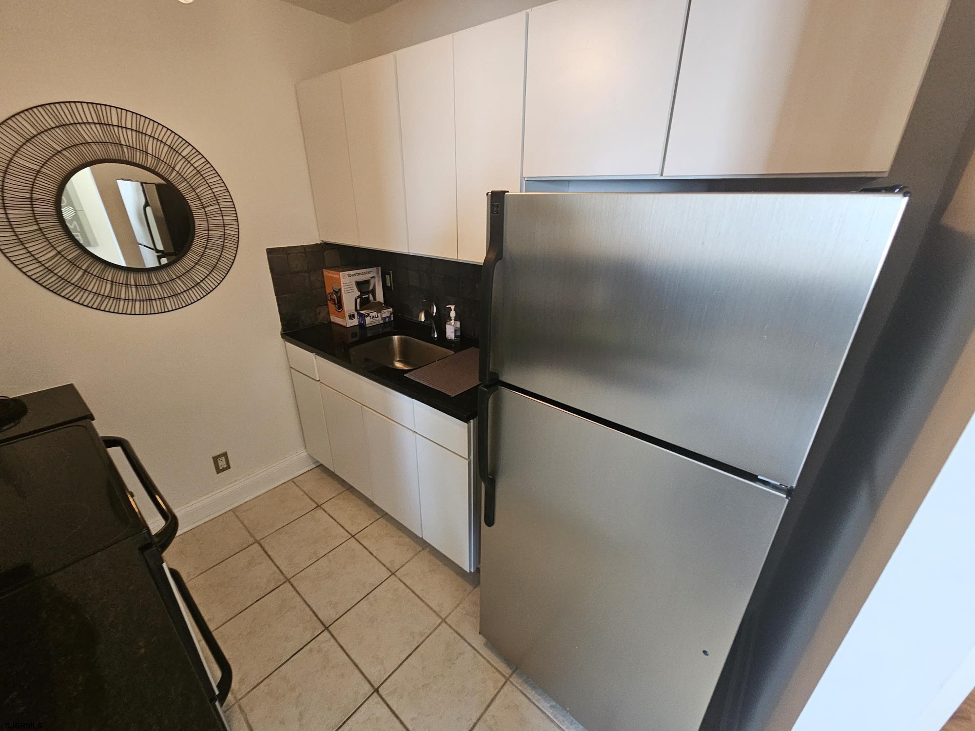 101 South Raleigh Avenue, Unit 734 Atlantic City, NJ 08401 - Photo 11 of 32 a kitchen with a refrigerator and a stove