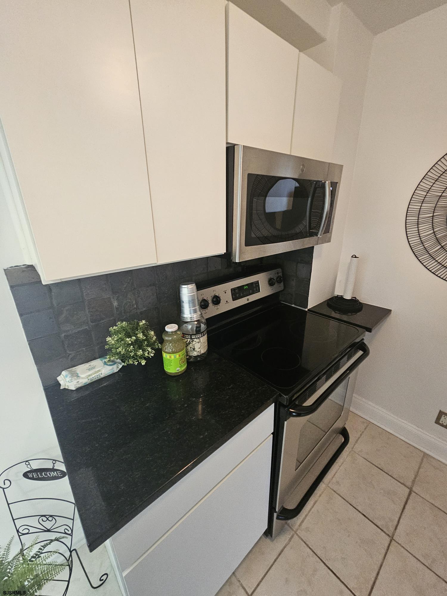 101 South Raleigh Avenue, Unit 734 Atlantic City, NJ 08401 - Photo 12 of 32 a kitchen with a stove and a microwave