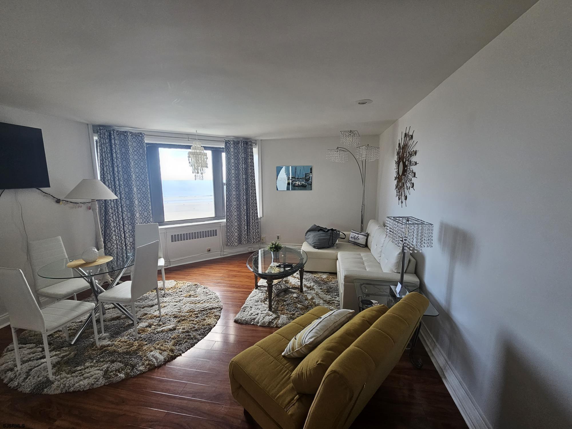 101 South Raleigh Avenue, Unit 734 Atlantic City, NJ 08401 - Photo 2 of 32 a living room with furniture and wooden floor