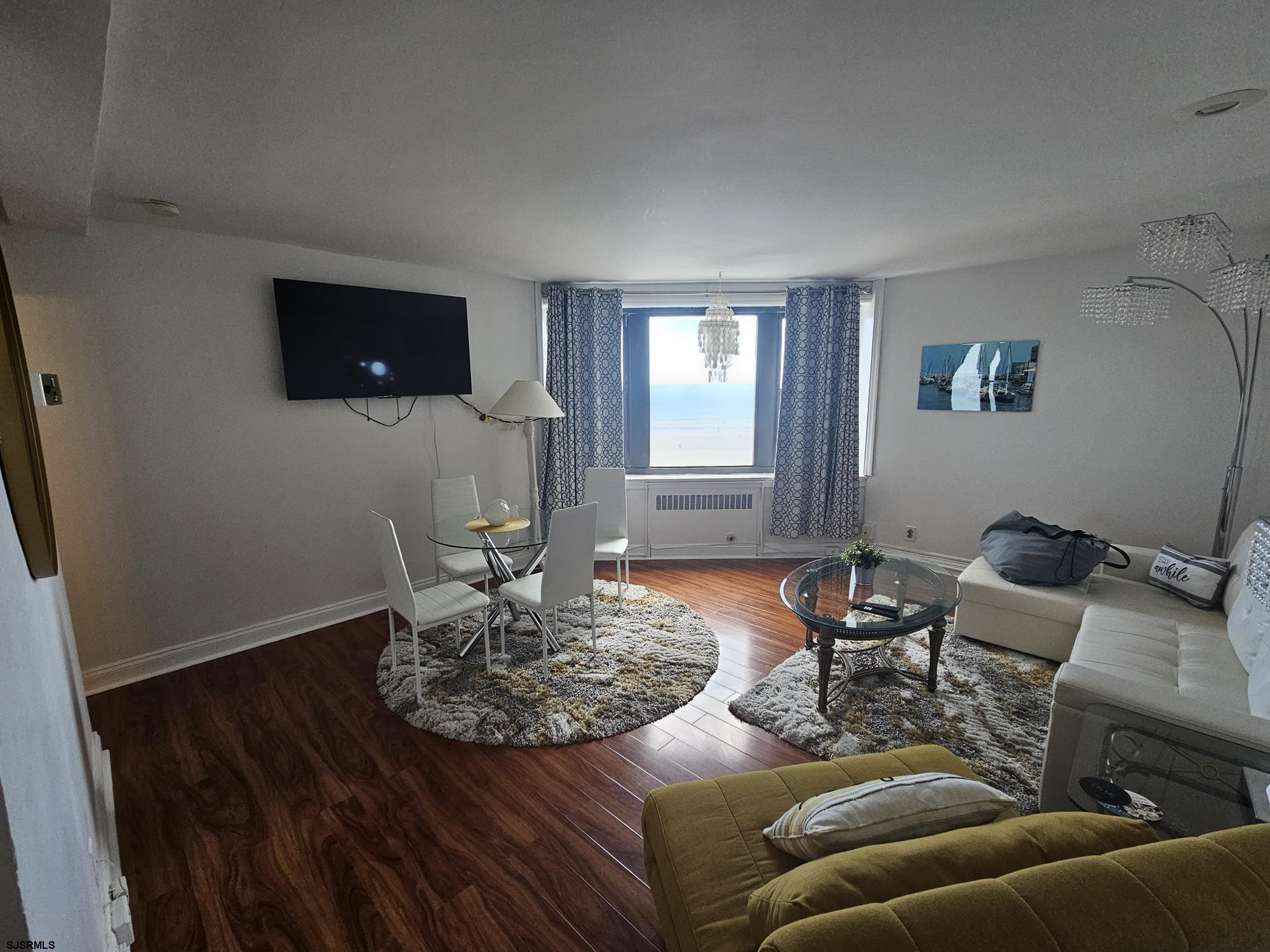 101 South Raleigh Avenue, Unit 734 Atlantic City, NJ 08401 - Photo 3 of 32 a living room with furniture and a flat screen tv