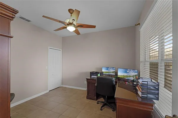 a view of a workspace with furniture and a window