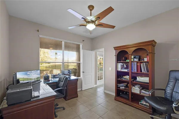 a living room with furniture a window and a bookshelf