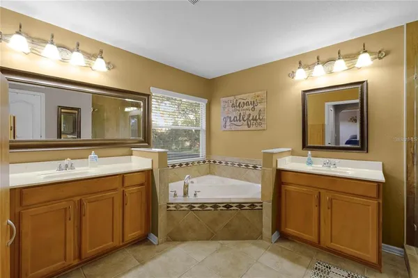a bathroom with a tub sink and mirror