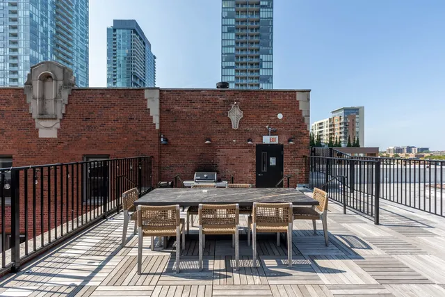 a view of a dinning tables and chairs in the roof deck