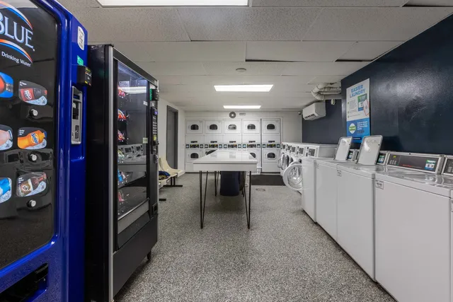 a kitchen with appliances a sink and cabinets