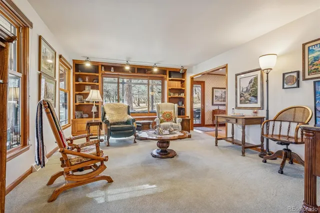 a view of a livingroom with furniture and a window