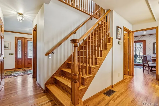 a view of a backyard with table and chairs with wooden floor and fence