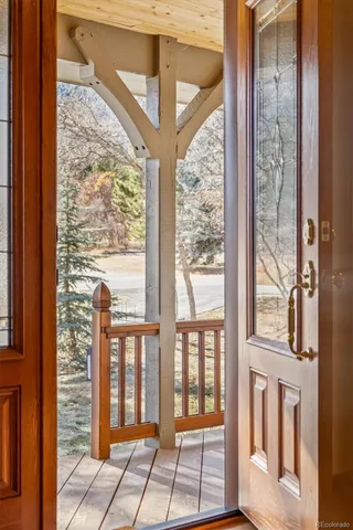 a large kitchen with stainless steel appliances granite countertop a stove top oven a sink dishwasher a dining table and chairs with wooden floor