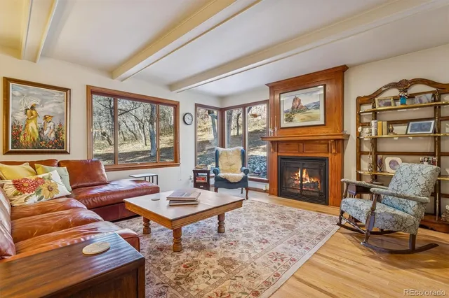 a view of a dining room with furniture large windows and wooden floor