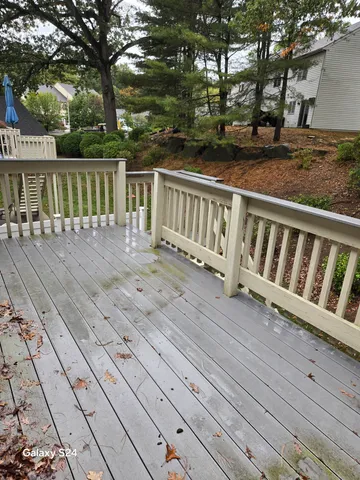 a view of balcony with wooden floor and fence
