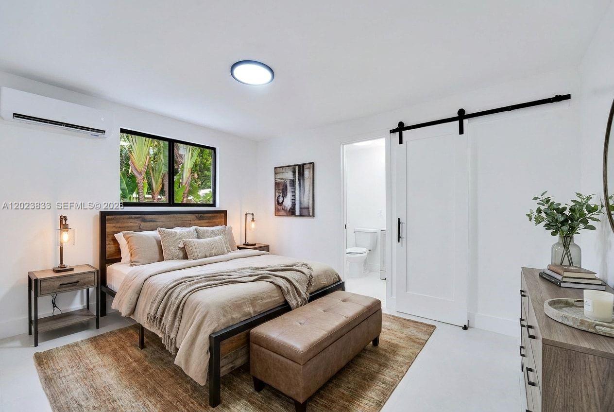 6566 Southwest 35th Street Miami, FL 33155 - Photo 25 of 36 a bedroom with a bed couch and a window