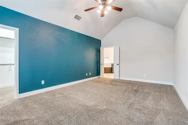 an empty room with chandelier fan