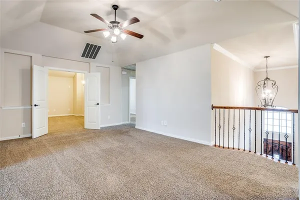 a view of an empty room and a ceiling fan