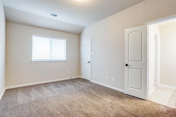 an empty room with windows and closet