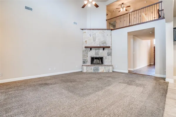 an empty room with cabinet and a fireplace