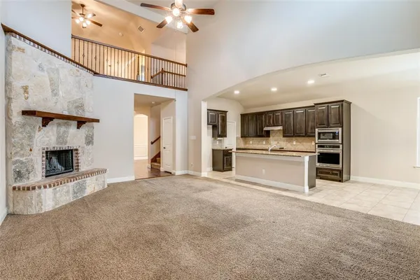 a view of a kitchen with a sink and a fireplace