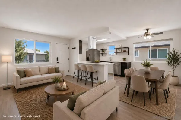 a living room with furniture and a dining table with kitchen view