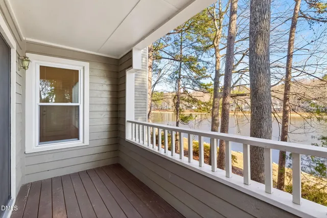 a view of a wooden balcony with a yard