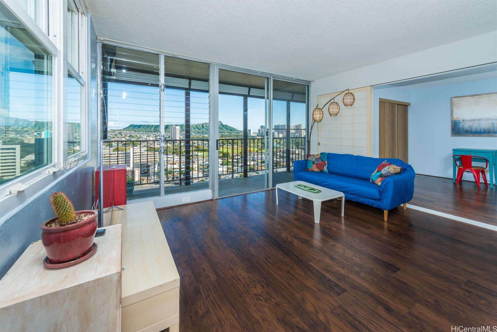 a living room with furniture and a floor to ceiling window