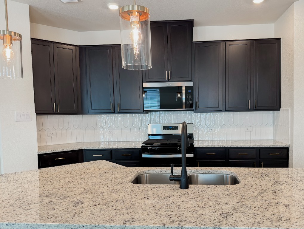4024 Pinto Lane Round Rock, TX 78665 - Photo 13 of 31 a kitchen with a refrigerator and a stove top oven