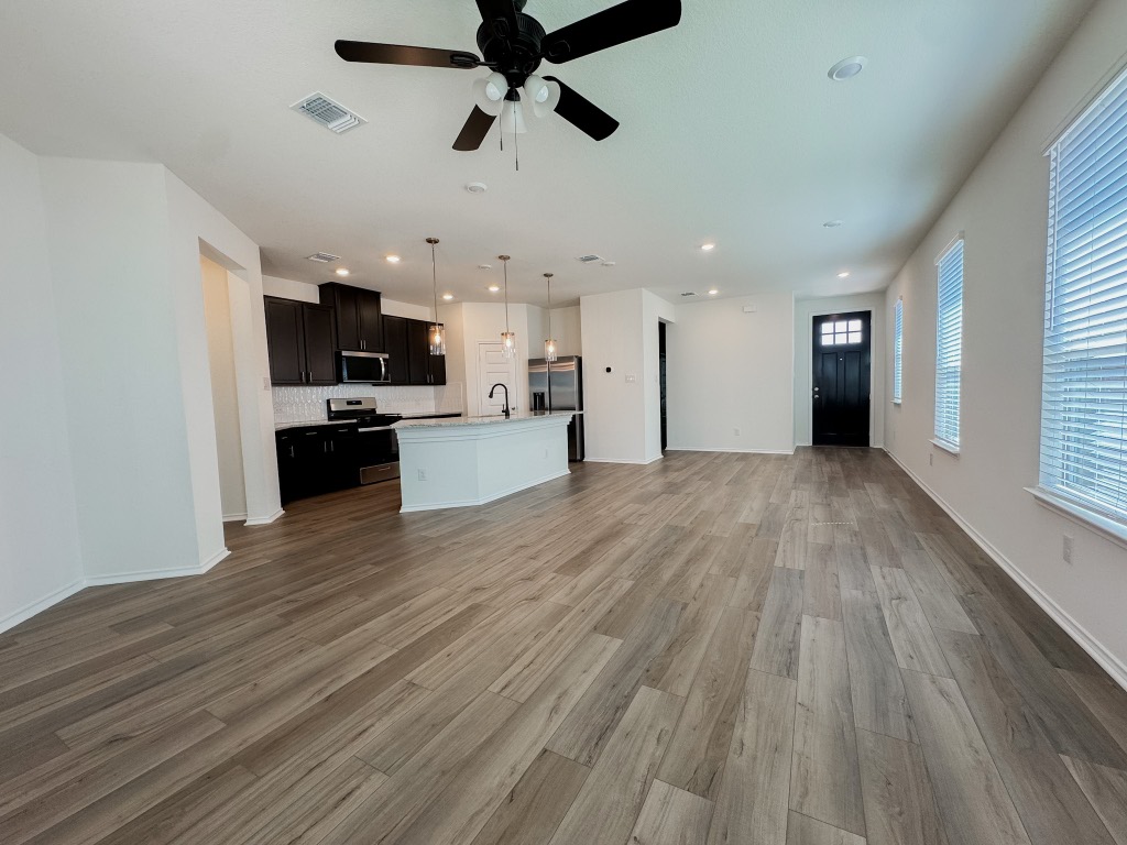 4024 Pinto Lane Round Rock, TX 78665 - Photo 2 of 31 a view of a kitchen with a sink and a microwave