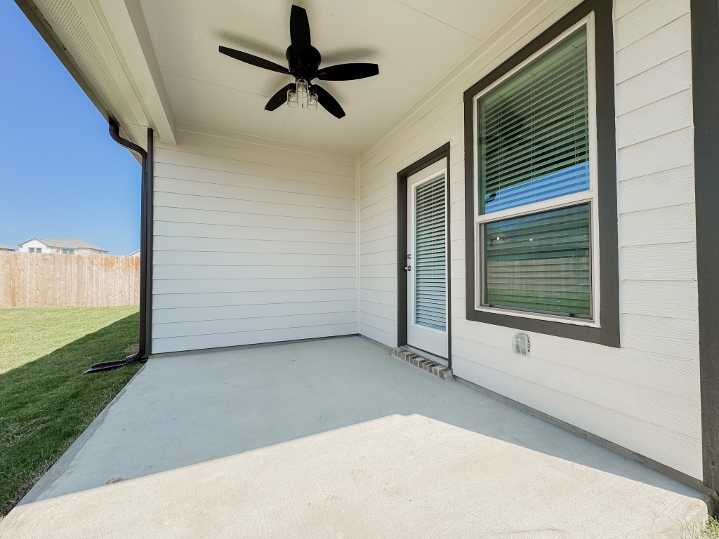 4024 Pinto Lane Round Rock, TX 78665 - Photo 27 of 31 Back patio is covered with a ceiling fan.