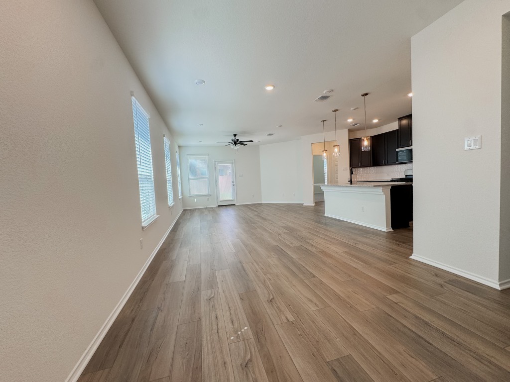 4024 Pinto Lane Round Rock, TX 78665 - Photo 6 of 31 a view of a big room with wooden floor and windows