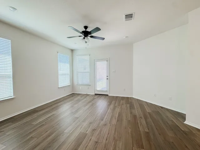 a large kitchen with stainless steel appliances granite countertop a stove top oven a refrigerator and a sink