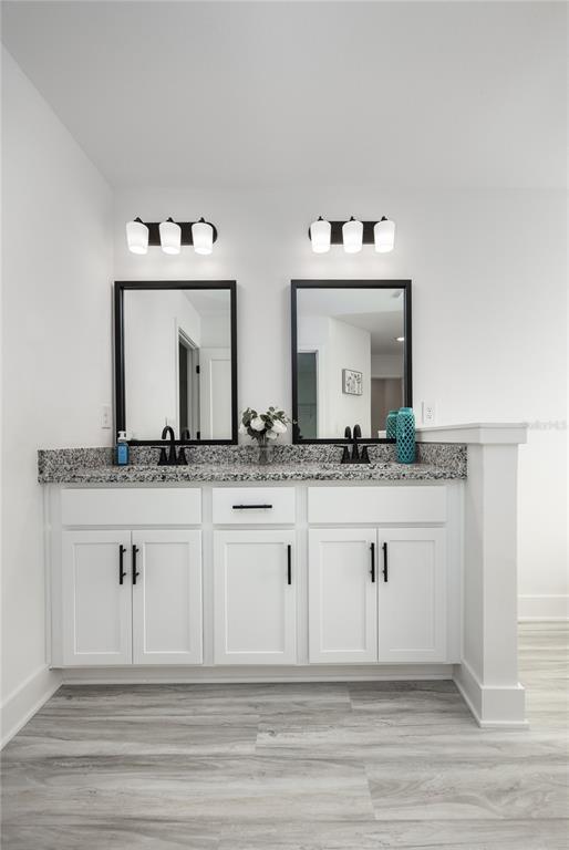 16929 Northwest 176th Way Alachua, FL 32615 - Photo 20 of 35 a bathroom with double vanity sinks and a mirror