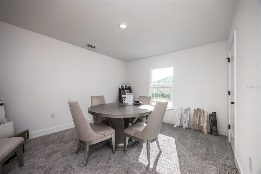 16929 Northwest 176th Way Alachua, FL 32615 - Photo 28 of 35 a view of a dining room with furniture