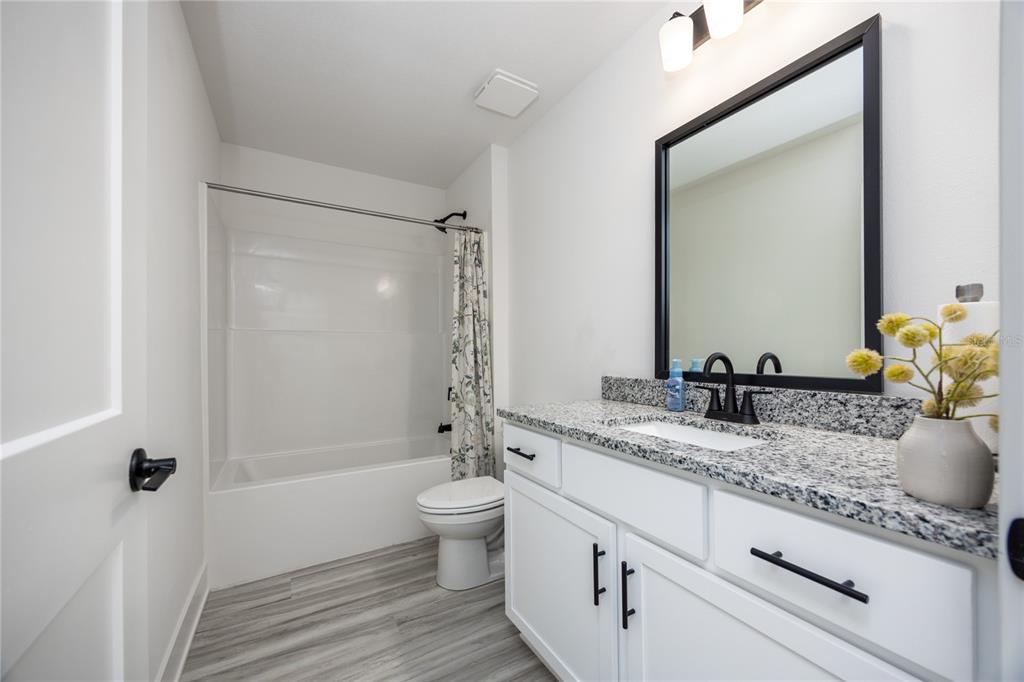 16929 Northwest 176th Way Alachua, FL 32615 - Photo 29 of 35 a bathroom with a granite countertop sink and a mirror