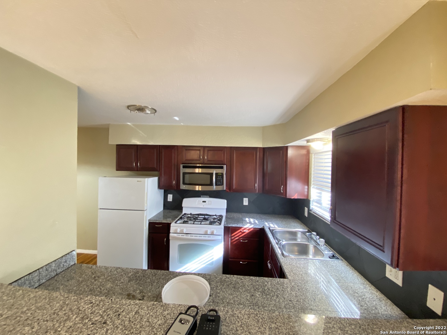211 Natalen Avenue, Unit 203 San Antonio, TX 78209 - Photo 2 of 7 a kitchen with stainless steel appliances granite countertop a refrigerator stove and sink