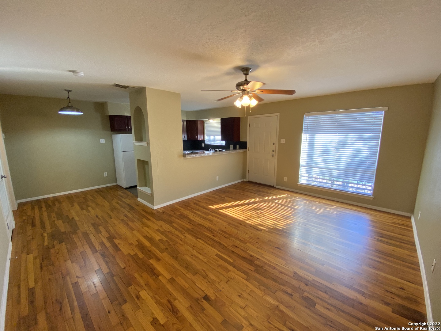211 Natalen Avenue, Unit 203 San Antonio, TX 78209 - Photo 3 of 7 a view of a room with wooden floor and ceiling fan