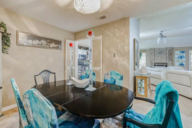 a dining room with furniture a rug and wooden floor