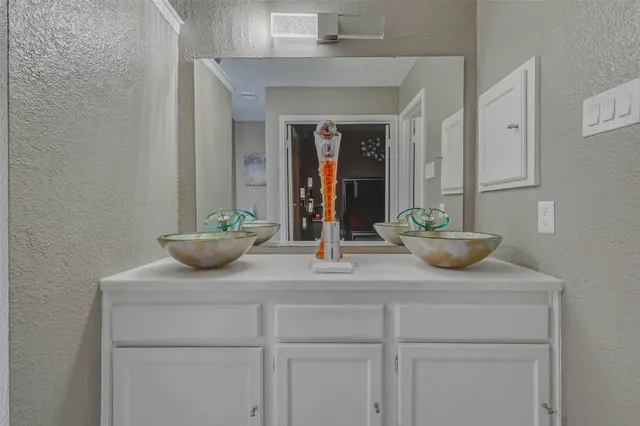 a view of room with a potted plant on the counter and cabinets
