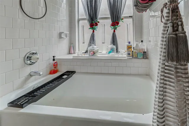 a bathroom with a bathtub and a sink