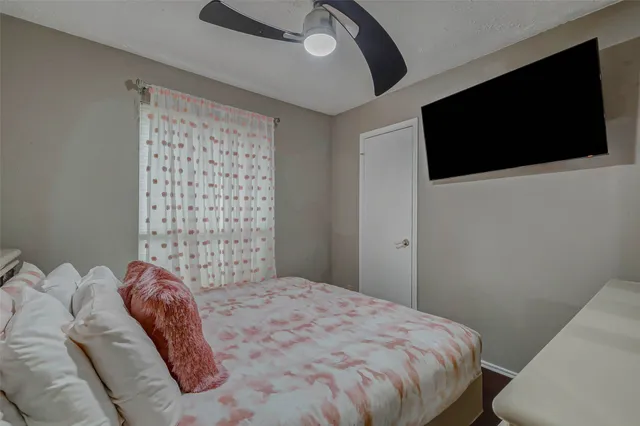 a bedroom with a large bed and a flat screen tv