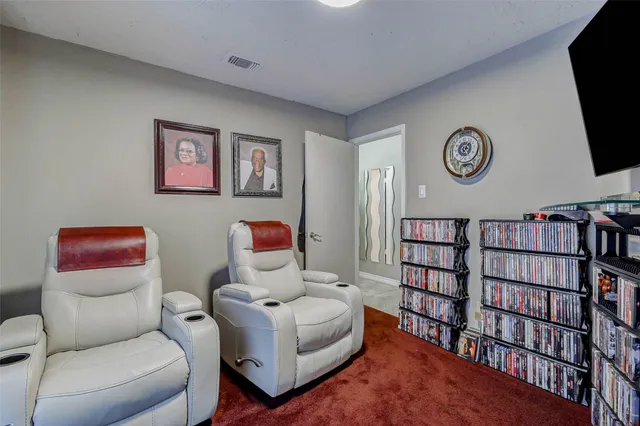 a reading room with furniture and a book shelf