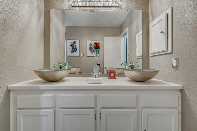 a view of bathroom with a sink and a mirror