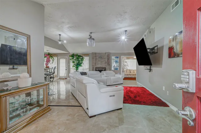 a living room with furniture and a flat screen tv