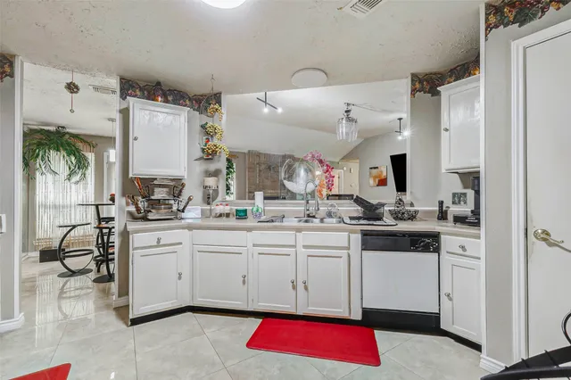 a kitchen with stainless steel appliances granite countertop a sink and cabinets