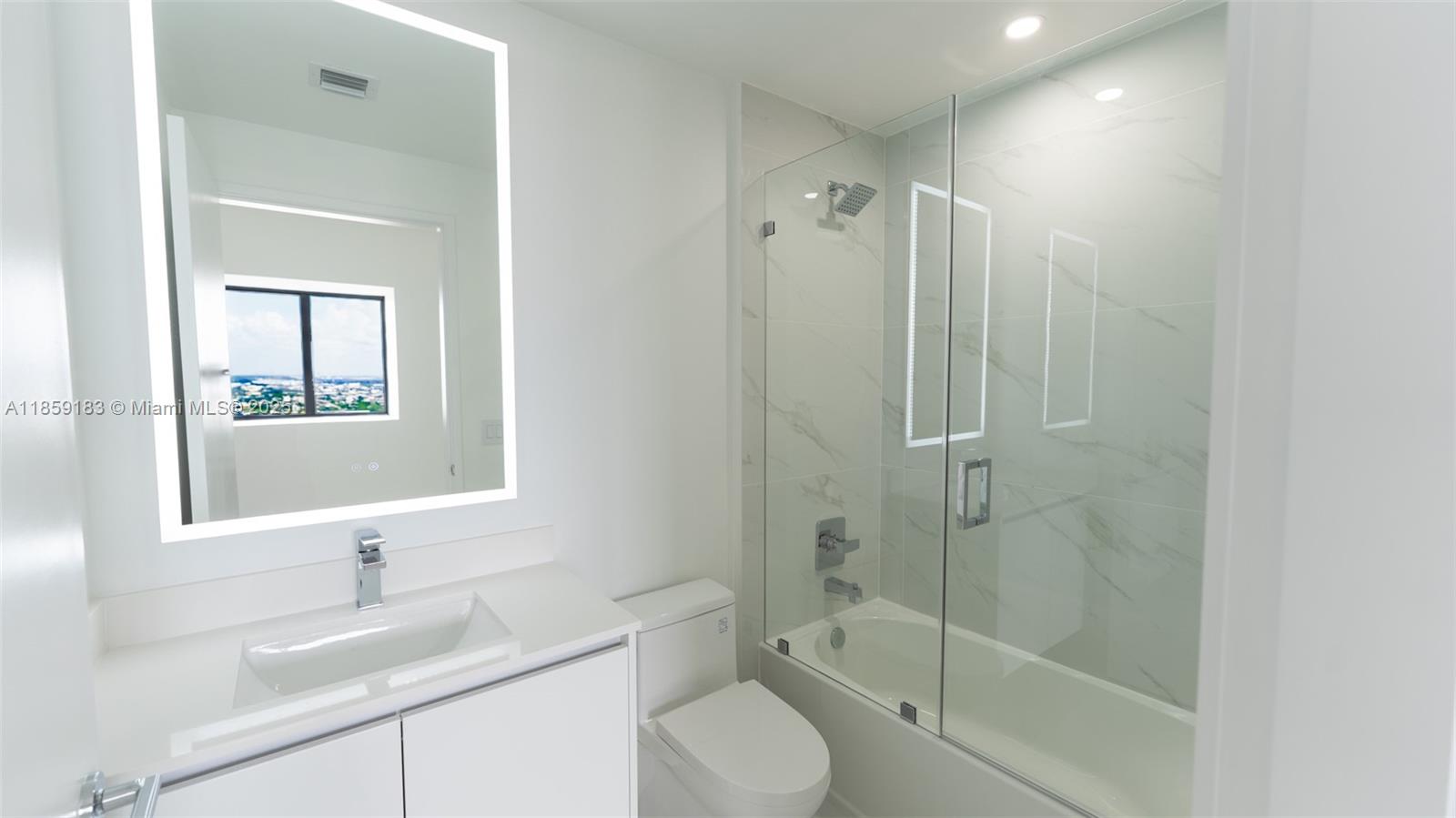 700 Northeast 24th Street, Unit 2905 Miami, FL 33137 - Photo 18 of 36 a bathroom with a sink toilet and shower