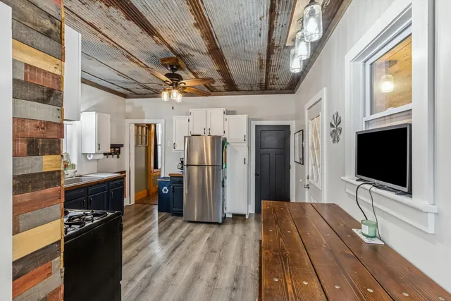 a view of a livingroom with furniture and a flat screen tv