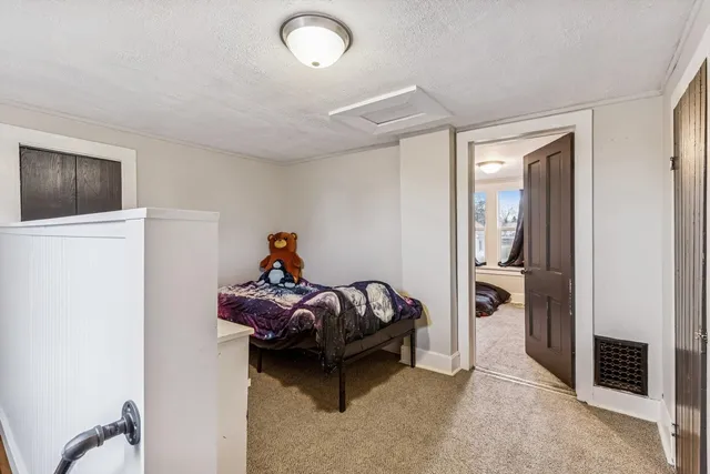 a bedroom with a bed and a tv