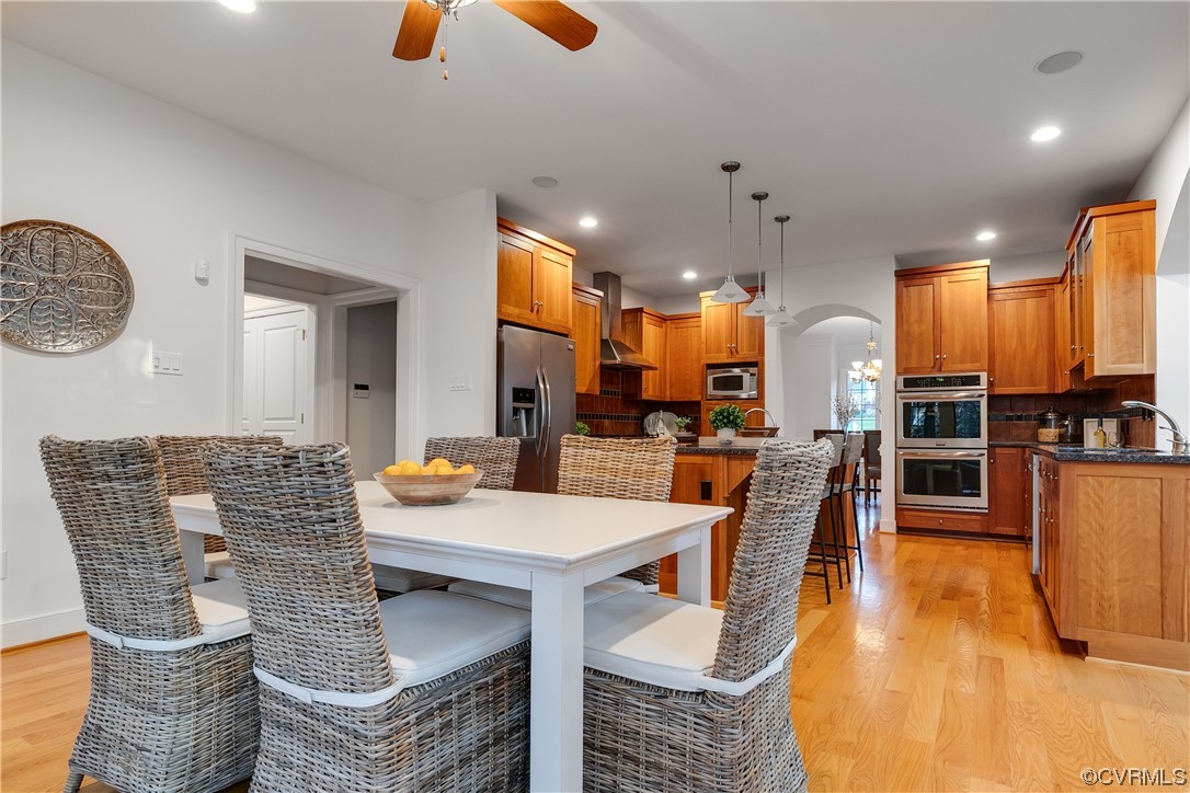 12110 Iron Forge Drive Midlothian, VA 23113 - Photo 12 of 50 a dining room with stainless steel appliances kitchen island granite countertop a table chairs and a view of living room