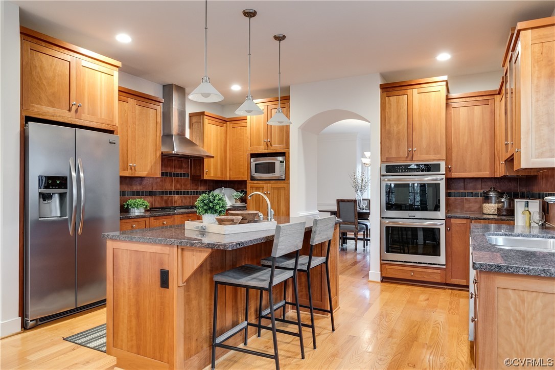 12110 Iron Forge Drive Midlothian, VA 23113 - Photo 15 of 50 a kitchen with stainless steel appliances a dining table chairs sink and stove top oven