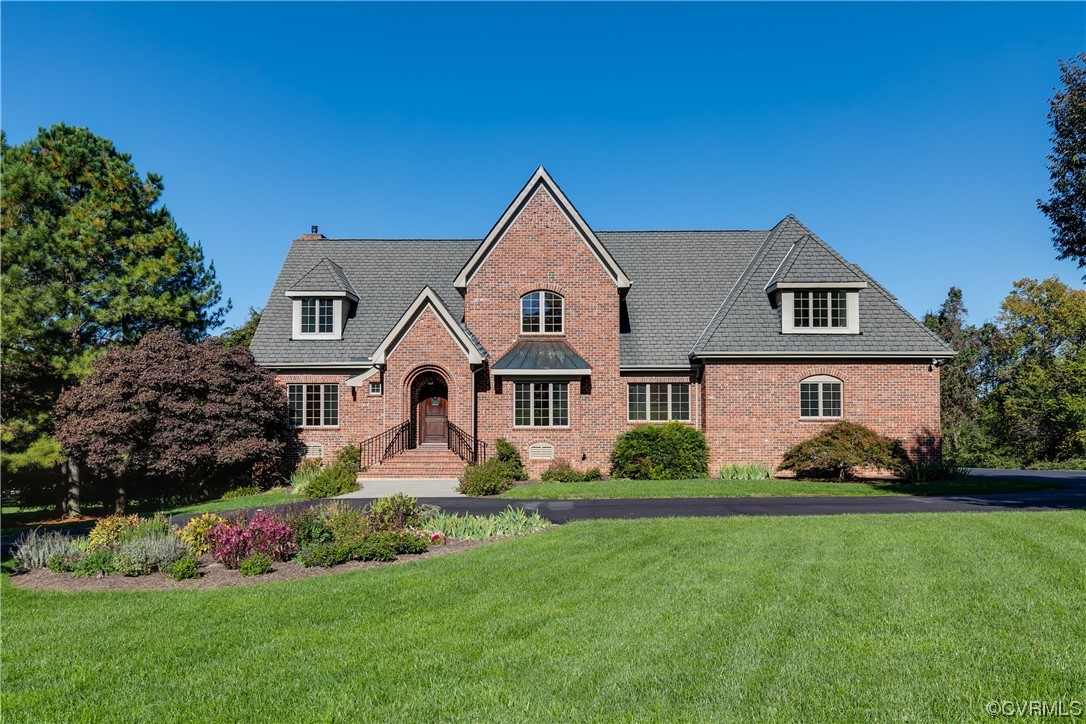 12110 Iron Forge Drive Midlothian, VA 23113 - Photo 2 of 50 a front view of a house with a garden and plants